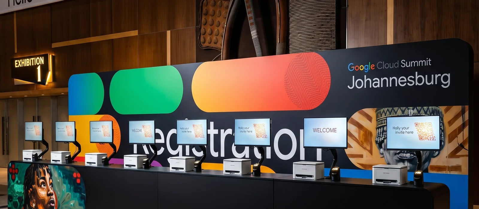 Concept visual of a wide branded registration environment with check-in screens and badge-printing stations